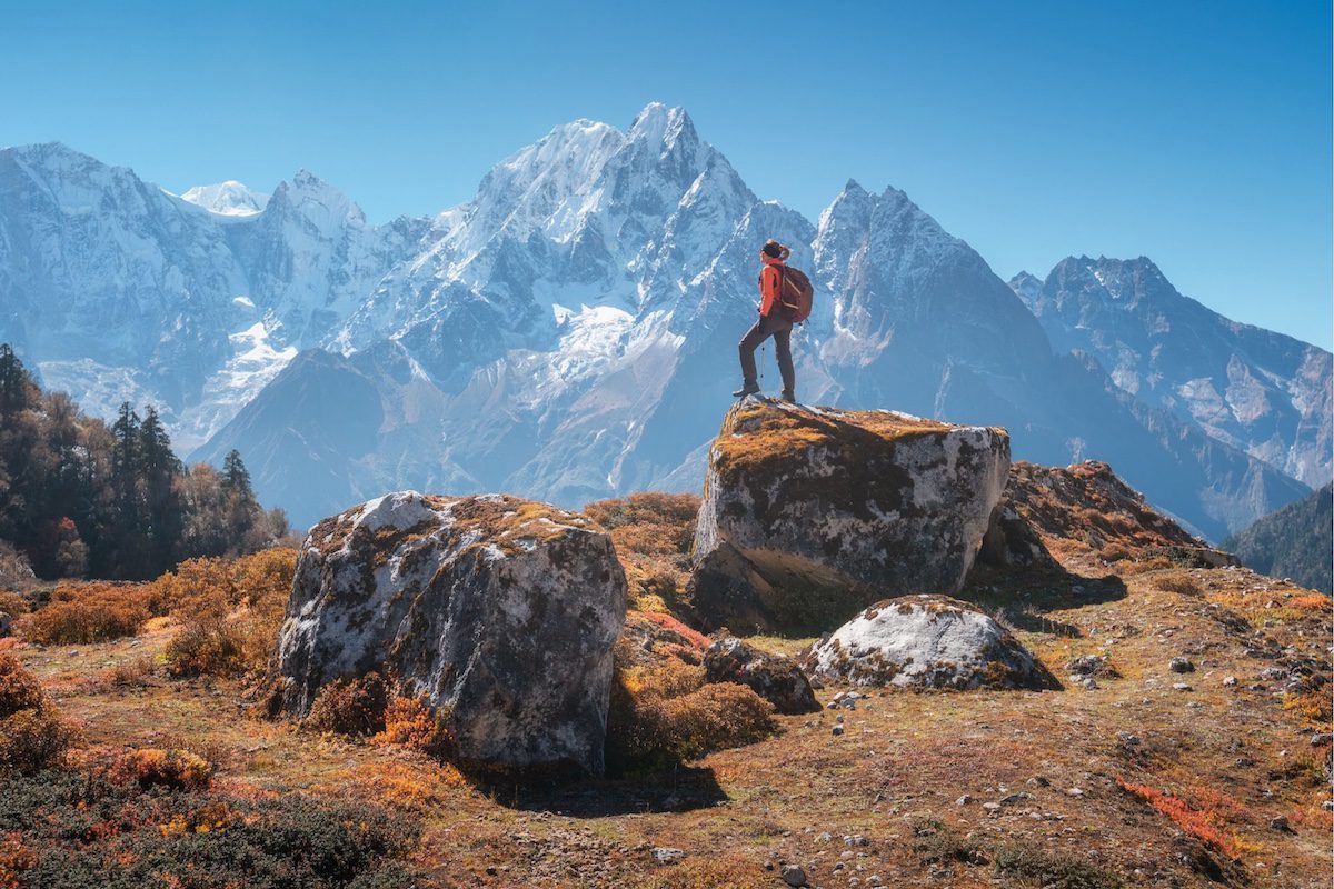 A woman hiking in Nepal on a trip with Reclaim Yourself