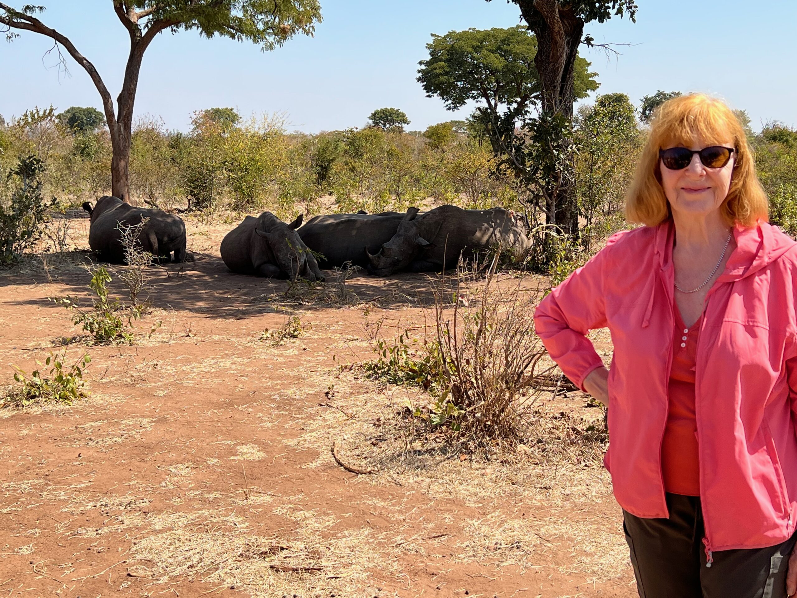 women in front or rhino in zambia